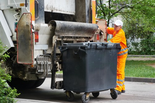Workers loading rubbish from a flat in Barnet